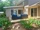 Backyard patio with outdoor furniture, plants, and sliding glass doors at 4506 Town Crier Sw Rd, Lilburn, GA 30047