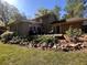 Landscaped backyard with a patio, lush lawn, and mature landscaping at 4506 Town Crier Sw Rd, Lilburn, GA 30047