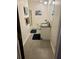 Bathroom featuring a vanity with a white cabinet, neutral paint, and tiled floors at 4506 Town Crier Sw Rd, Lilburn, GA 30047