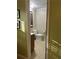 View of a small half bathroom with neutral tones and a wood-trimmed window at 4506 Town Crier Sw Rd, Lilburn, GA 30047