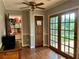 A dining area features wood floors, wood-trimmed doors, and glass-paned doors to the backyard at 4506 Town Crier Sw Rd, Lilburn, GA 30047