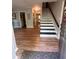 Inviting home foyer with wood-look floors and staircase to the upper level at 4506 Town Crier Sw Rd, Lilburn, GA 30047