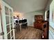 Bright office space with wood-look floors, French doors, and natural light at 4506 Town Crier Sw Rd, Lilburn, GA 30047