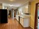A spacious kitchen boasts wood floors, white cabinets, and stainless-steel appliances at 4506 Town Crier Sw Rd, Lilburn, GA 30047