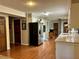A spacious kitchen boasts wood floors, white cabinets, and stainless-steel appliances at 4506 Town Crier Sw Rd, Lilburn, GA 30047