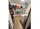 A laundry room features overhead storage shelves and a white washer and dryer at 4506 Town Crier Sw Rd, Lilburn, GA 30047