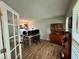Office boasts wood floors, a computer desk, and a wood cabinet with glass doors at 4506 Town Crier Sw Rd, Lilburn, GA 30047