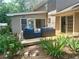 Inviting patio with comfortable seating surrounded by lush landscaping at 4506 Town Crier Sw Rd, Lilburn, GA 30047