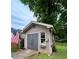 Exterior view of a shed, featuring an American flag and a window with a flower box at 4506 Town Crier Sw Rd, Lilburn, GA 30047