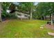 Large backyard featuring mature trees, partial fence and multi level deck at 5290 River Mill Cir, Marietta, GA 30068