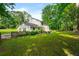 Backyard featuring a manicured lawn, partial fence, and mature trees at 5290 River Mill Cir, Marietta, GA 30068