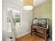 Bright bedroom features hardwood floors, a window overlooking the front yard, and unique wallpaper at 5290 River Mill Cir, Marietta, GA 30068