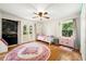 Sunlit bedroom boasts hardwood floors, a chalkboard wall, and access to outdoor space at 5290 River Mill Cir, Marietta, GA 30068