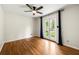 Bright bedroom with wood floors, ceiling fan, and french doors leading to the outside at 5290 River Mill Cir, Marietta, GA 30068