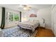 Bedroom featuring a ceiling fan, window, and bed with patterned bedding and a nightstand at 5290 River Mill Cir, Marietta, GA 30068