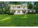 Two-story white home with a large, well-maintained lawn and a double-decker front balcony at 5290 River Mill Cir, Marietta, GA 30068