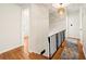 Upstairs hallway features hardwood floors, iron railings, and access to the bedrooms at 5290 River Mill Cir, Marietta, GA 30068