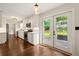 Bright kitchen boasts white cabinetry, stainless steel appliances, hardwood flooring, and access to the backyard at 5290 River Mill Cir, Marietta, GA 30068