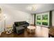 Bright living room with hardwood floors, green accents, and natural light from large windows at 5290 River Mill Cir, Marietta, GA 30068