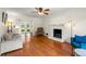 Bright living room features hardwood floors, a white brick fireplace, and access to the backyard at 5290 River Mill Cir, Marietta, GA 30068