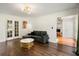 Inviting living room showcasing French doors, modern light fixture, and a view to the fireplace at 5290 River Mill Cir, Marietta, GA 30068