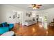 Open living room features hardwood floors, neutral paint, modern furniture, and access to the kitchen at 5290 River Mill Cir, Marietta, GA 30068