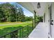 View of the porch with black railing and lots of shade trees at 5290 River Mill Cir, Marietta, GA 30068