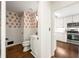 Stylish half-bathroom with patterned wallpaper, vanity and sink, and dark hardwood floors at 5290 River Mill Cir, Marietta, GA 30068