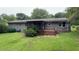 Rear exterior view with a patio, porch, and lush green yard at 5924 Central Church Rd, Douglasville, GA 30135