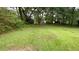 Expansive backyard, featuring lush green grass and mature trees at 5924 Central Church Rd, Douglasville, GA 30135