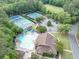 Community center aerial with a pool, tennis courts, clubhouse and parking, surrounded by lush greenery at 10400 Groomsbridge Rd, Alpharetta, GA 30022