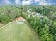 Aerial view of a community recreational area with playground, athletic fields, and picnic areas nestled in greenery at 10400 Groomsbridge Rd, Alpharetta, GA 30022