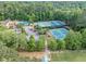 Aerial view showcasing a community center with tennis courts, swimming pool, and a gathering area at 10400 Groomsbridge Rd, Alpharetta, GA 30022