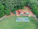 A community playground with play structures, basketball and volleyball courts, set amongst mature trees at 10400 Groomsbridge Rd, Alpharetta, GA 30022