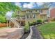 A spacious backyard with a patio, deck, lush lawn and mature landscaping at 10400 Groomsbridge Rd, Alpharetta, GA 30022