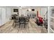 Basement area with full dining set, workout equipment, drum set, and access to the backyard at 10400 Groomsbridge Rd, Alpharetta, GA 30022