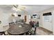 Basement area with full dining set, workout equipment, drum set, and access to the backyard at 10400 Groomsbridge Rd, Alpharetta, GA 30022