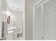 This charming powder room features a vanity sink, neutral color palette, and a wall mounted light at 10400 Groomsbridge Rd, Alpharetta, GA 30022