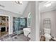 Modern bathroom featuring a glass shower, a free standing tub, and an arched window with shutters at 10400 Groomsbridge Rd, Alpharetta, GA 30022