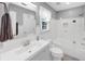Bright bathroom featuring a white vanity, subway tile, and glass shower door at 10400 Groomsbridge Rd, Alpharetta, GA 30022