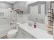 Bathroom with a tiled shower and tub combination, a white vanity and tile floors at 10400 Groomsbridge Rd, Alpharetta, GA 30022