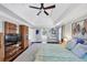 Bright bedroom features a ceiling fan, a vaulted ceiling, and multiple windows, and hardwood floors at 10400 Groomsbridge Rd, Alpharetta, GA 30022