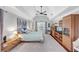 Bright bedroom features a ceiling fan, a vaulted ceiling, and multiple windows, and hardwood floors at 10400 Groomsbridge Rd, Alpharetta, GA 30022