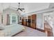Bright bedroom features a ceiling fan, a vaulted ceiling, and multiple windows, and hardwood floors at 10400 Groomsbridge Rd, Alpharetta, GA 30022