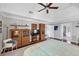 Bright bedroom features a ceiling fan, a vaulted ceiling, and multiple windows, and hardwood floors at 10400 Groomsbridge Rd, Alpharetta, GA 30022
