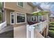View of an outdoor deck with ample space for seating and entertaining, with house details at 10400 Groomsbridge Rd, Alpharetta, GA 30022