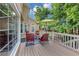Outdoor deck area with comfortable seating, perfect for relaxing and entertaining guests at 10400 Groomsbridge Rd, Alpharetta, GA 30022
