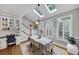 Spacious dining room featuring a table for four, a desk and plenty of natural light from three windows at 10400 Groomsbridge Rd, Alpharetta, GA 30022