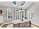 Light filled dining room features three windows with shutters and two skylights for ample natural light at 10400 Groomsbridge Rd, Alpharetta, GA 30022