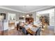 Elegant dining room with hardwood floors and a view to the staircase and open kitchen at 10400 Groomsbridge Rd, Alpharetta, GA 30022